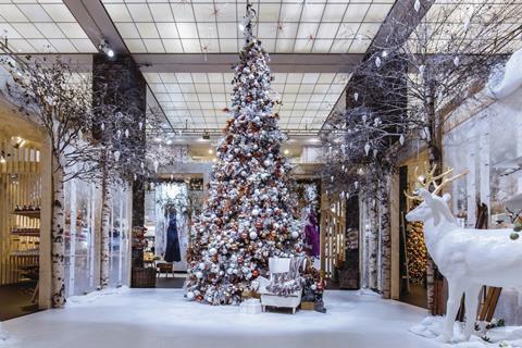 KaDeWe's main atrium has been set aside for a floor-to-ceiling Christmas tree surrounded by snow.